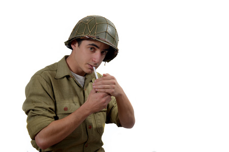 American soldierwith M1 helmet   lights a cigaretteの写真素材
