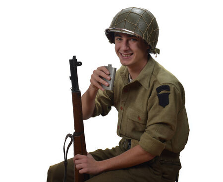 young American soldier takes a sip of alcohol, he have a M1 gunの写真素材