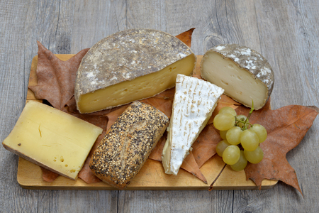 tray different french cheeses on a wooden trayの写真素材