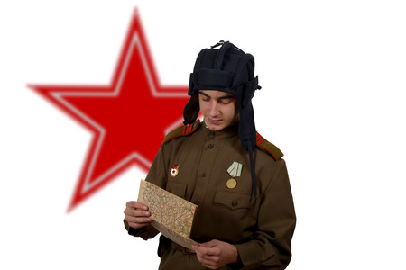 young Soviet tanker look at a map の写真素材