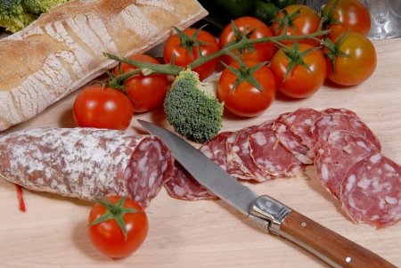 sausage cut into slices around tomatoの写真素材