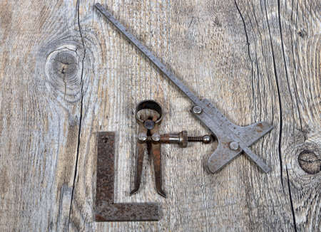 old measuring instruments for mechanic on the wood tableの写真素材
