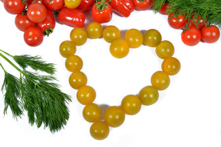 small yellow tomatoes forming a heart with red tomatoesの写真素材