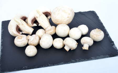 Paris mushrooms on a slate plateの写真素材