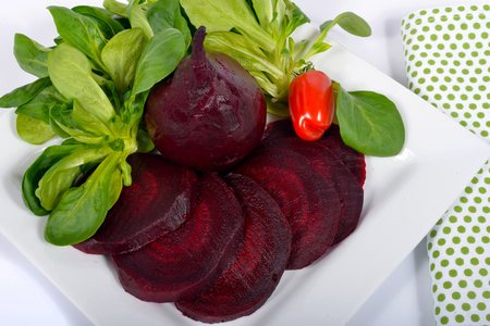plate of beet salad isolated on a white backgroundの写真素材