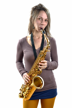 young woman playing the saxophone on white backgroundの写真素材