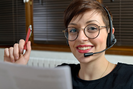 Female customer support operator with headset and smiling