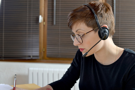 Portrait of a happy young businesswoman with headset