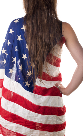 young woman from back and long hair dressed with an American flagの写真素材