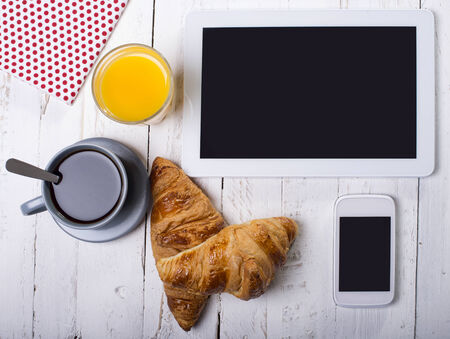 breakfast with tablett and mobile phoneの写真素材