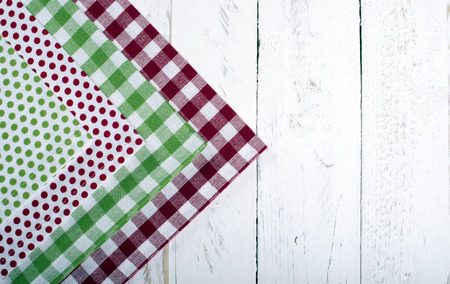 towels red and green table on a white wooden board