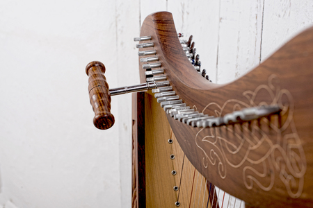 closeup on the setting up of a harp with toolの写真素材