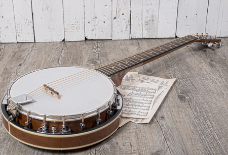 banjo with some sheets placed on the groundの写真素材