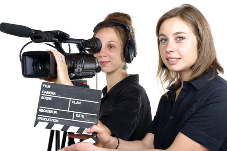 two young women with a video camera and a clapper boardの写真素材