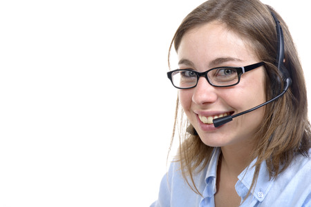a young switchboard operator smiling at the camera on white backgroundの写真素材