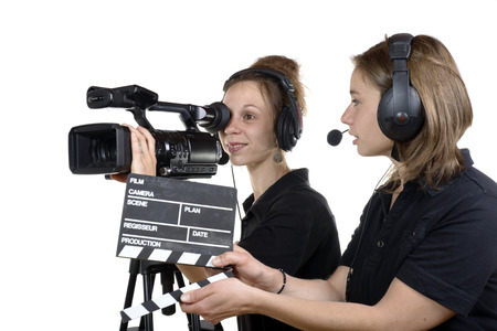 two young women with a video cameras on whiteの写真素材