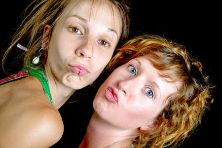 portrait of two young women on a black background
