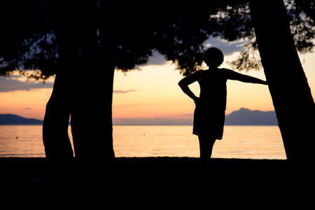 sunset at the beach with peopleの写真素材