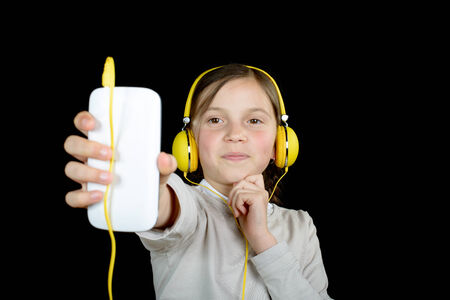 a beautiful young girl listening to music with a portable music playerの写真素材