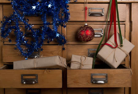 Christmas gifts in the drawer of a cabinetの写真素材