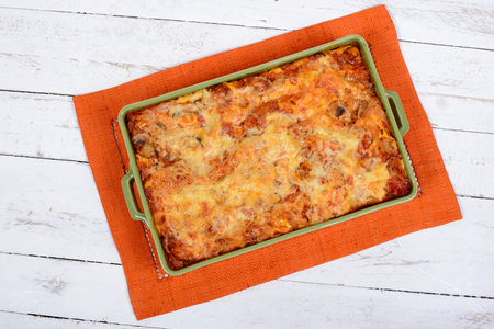 lasagna dish on orange towelの写真素材