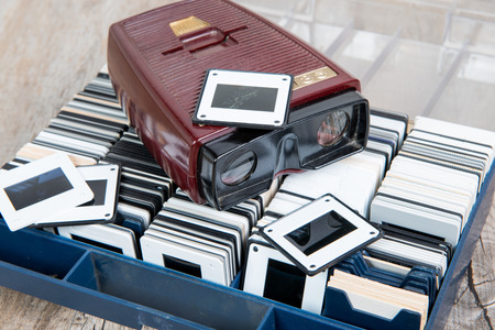 A Few viewer slides with old slides on the wooden tableの写真素材