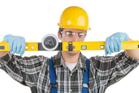 a young worker with a level on the white background