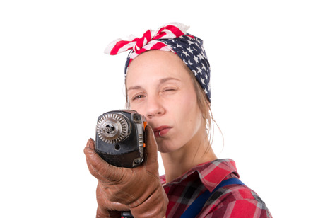 Vintage pretty young woman with a drill on the white backgroundの写真素材