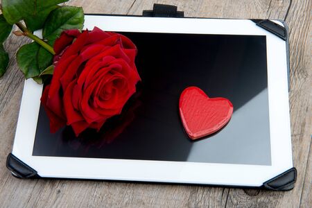 digital tablet with a rose and heart for valentine dayの写真素材