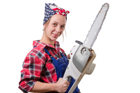 Vintage pretty young woman with a chainsaw on the white backgroundの写真素材