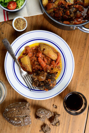 beef dish with carrots on the old tableの写真素材