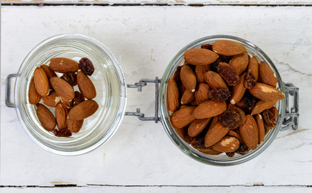almonds with dry grapes in a glass jarの写真素材