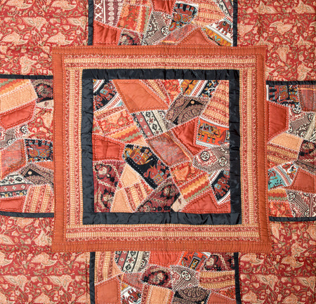 a patchwork background with different colored patterns