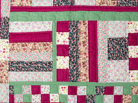 a patchwork background with different colored patterns