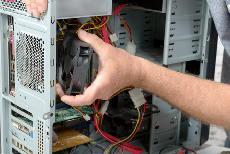 a technician changes the fan of a computerの写真素材