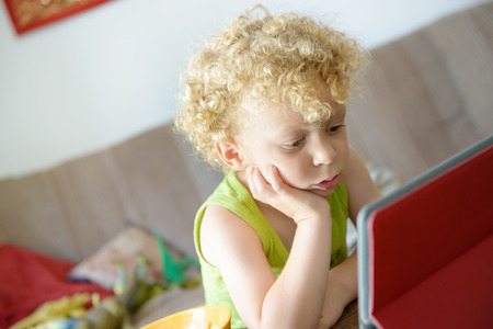 a little child looking at a digital tabletの写真素材