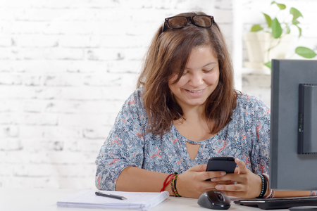 a teenage girl playing with her mobile phoneの写真素材