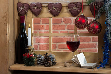 a glass of wine at the window, with a christmas decoration