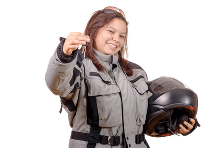 Low key portrait of a girl biker standing on white background