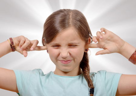 a little girl covering her ears,to say stop making loud noise giving me headacheの写真素材