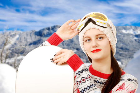 a portrait of a happy young girl snowboardingの写真素材