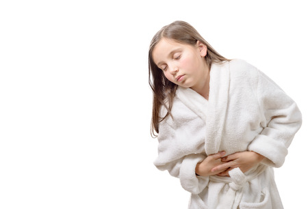a girl has a stomachache, isolated on white backgroundの写真素材