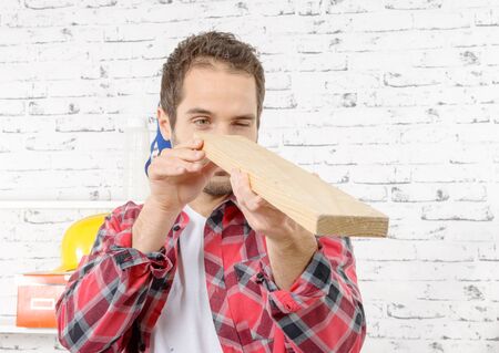 a young worker with a wooden board