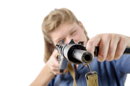 a young woman shooting with a gun isolated on a white background