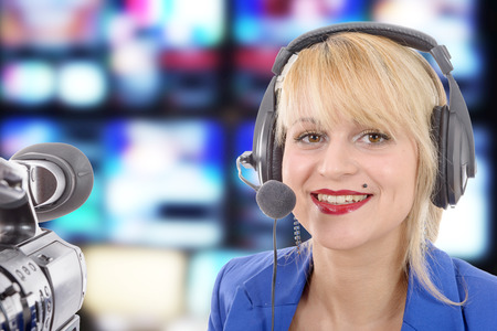 a beautiful young woman with a professional video camera and headphone