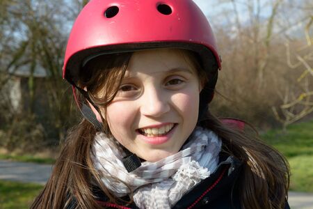a teenage girl wearing a roller helmet.の写真素材