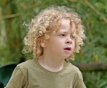 a little boy with blond hair and curlyの写真素材