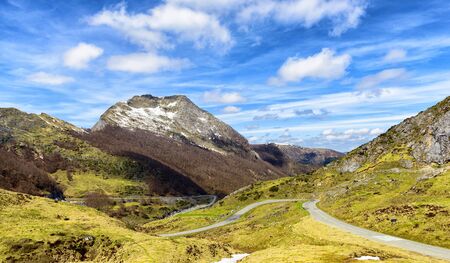 a mountain landscape with a winding roadの写真素材