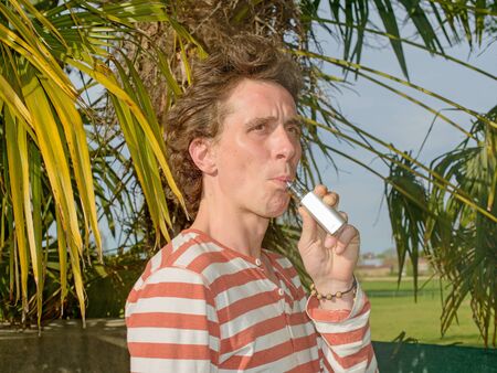 a man with an electronic cigaretteの写真素材