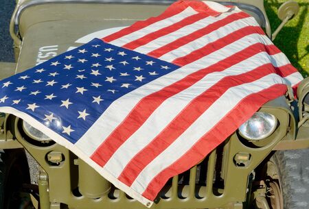 a ww2 military vehicle, with American flagの写真素材